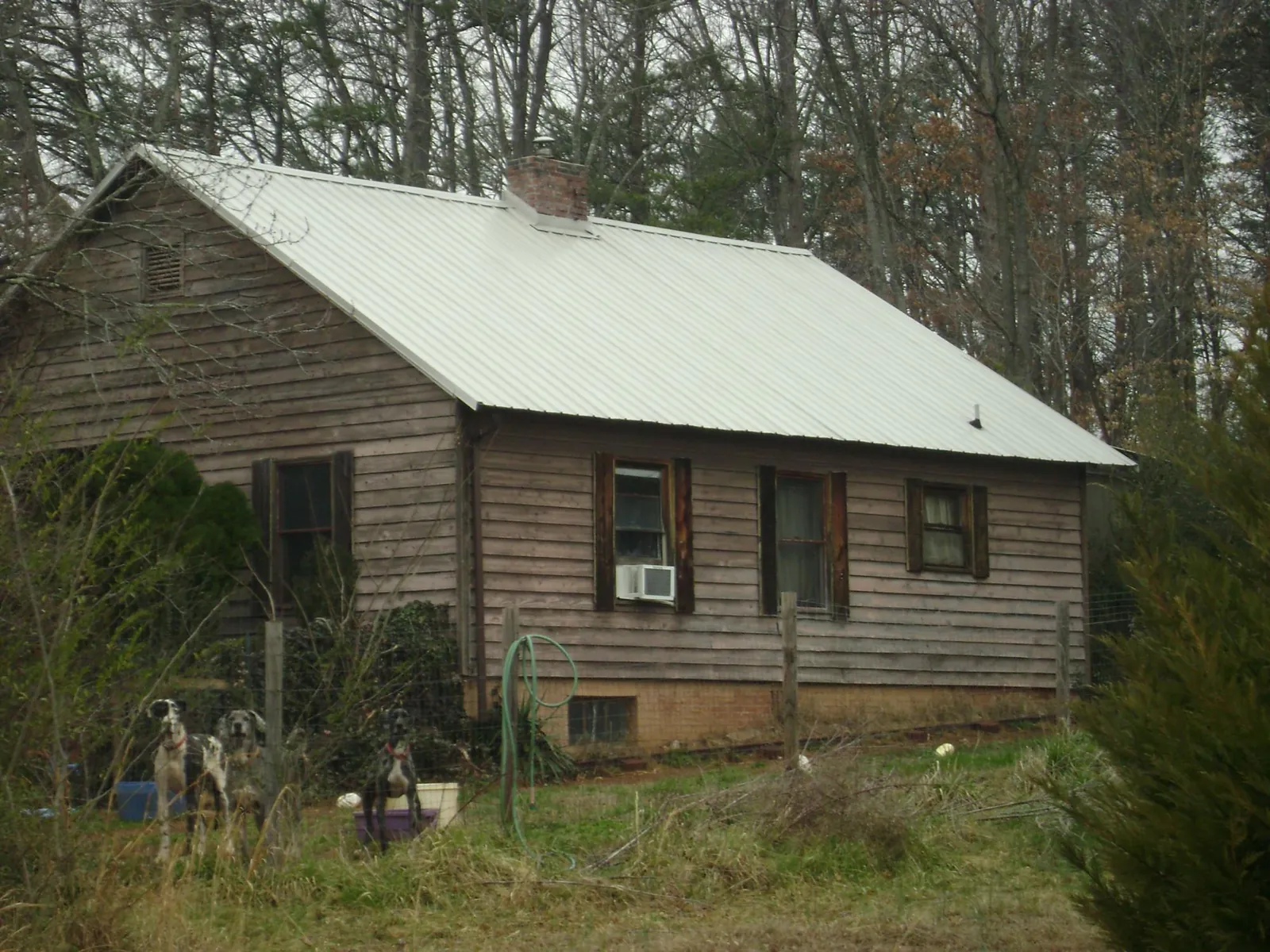 White metal roof on an old wood sided farmhouse, from a Metal Roof Installation job in Charlestown